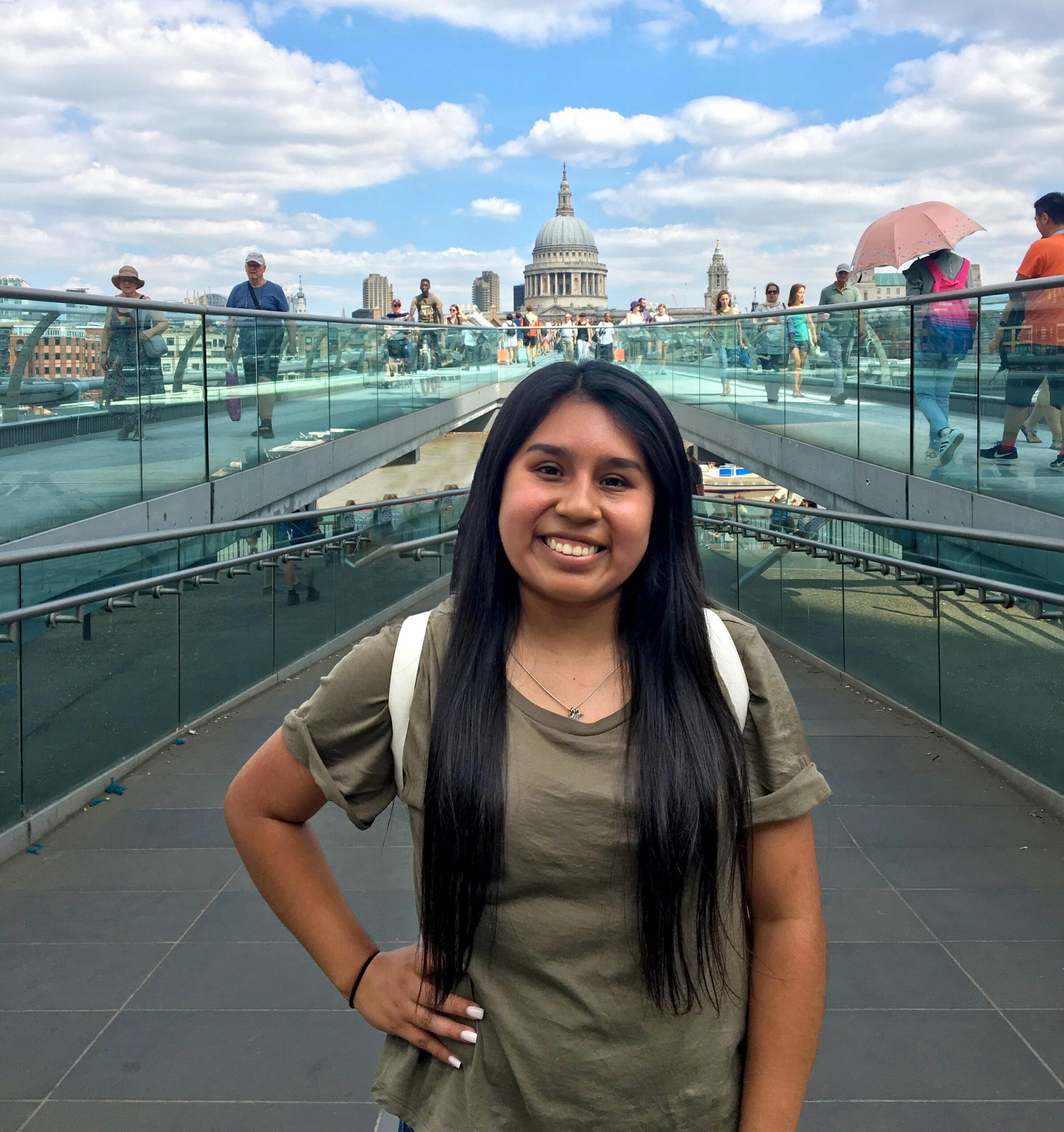 A female student in front of a dual stair case